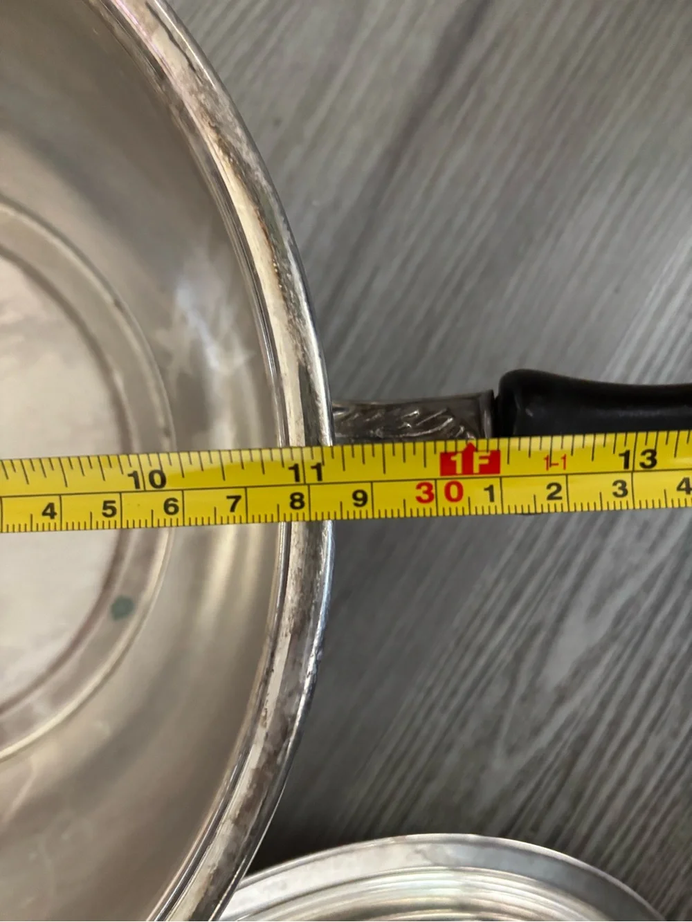 Pyrex glass insert inside a covered silver-plated pot with lid. Used
